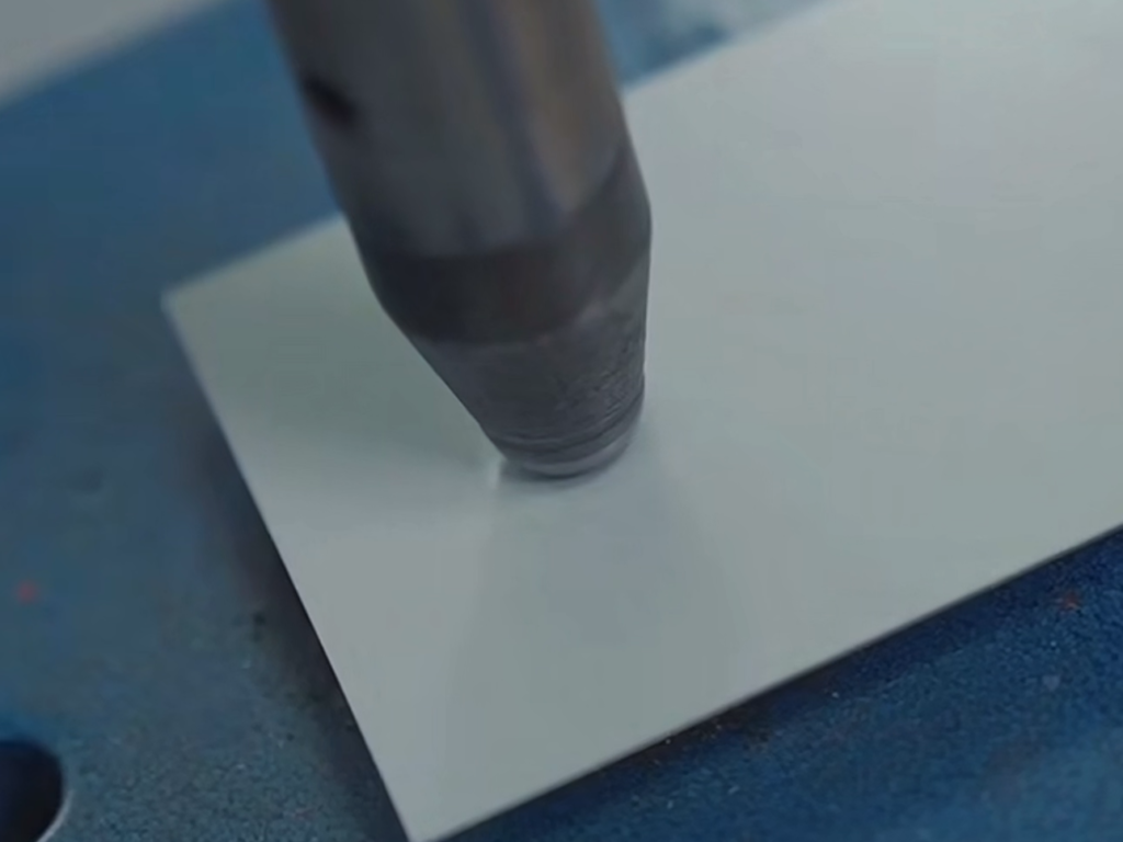 Impact resistance test on coated metal panel