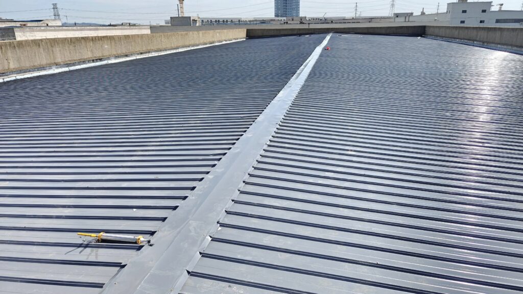 Prepainted metal roofing sheet installed on industrial roof with standing seam structure