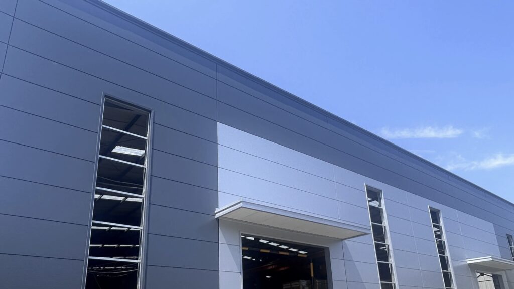 Architectural facade with colored aluminum panels and metal louver system